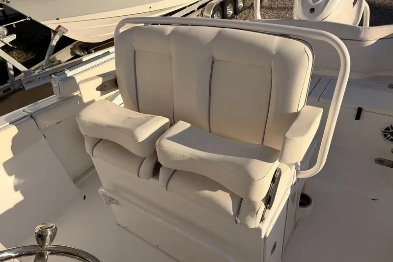 Slide: The Image of 2025 Sea Hunt Ultra 255 SE boat seating, featuring plush white upholstery and modern design. - 7