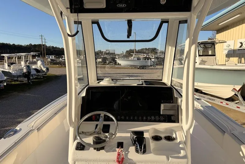 Slide: The Image of 2025 Sea Hunt Ultra 255 SE boat cockpit with steering wheel and controls. - 8