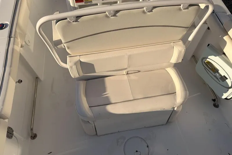 Slide: The Image of 2025 Sea Hunt Ultra 255 SE boat seating area with white cushioned seats. - 9