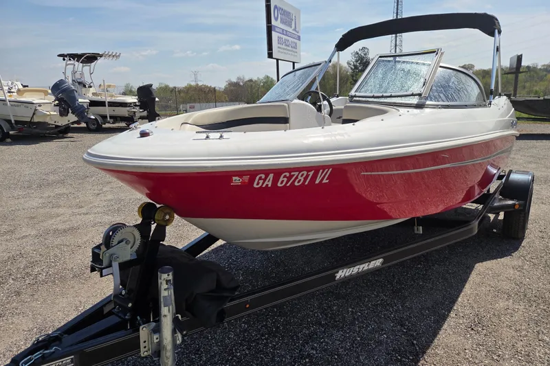 The Image of 2020 Starcraft Limited Runabout 172 OB Sport boat on trailer, red and white exterior. - 1
