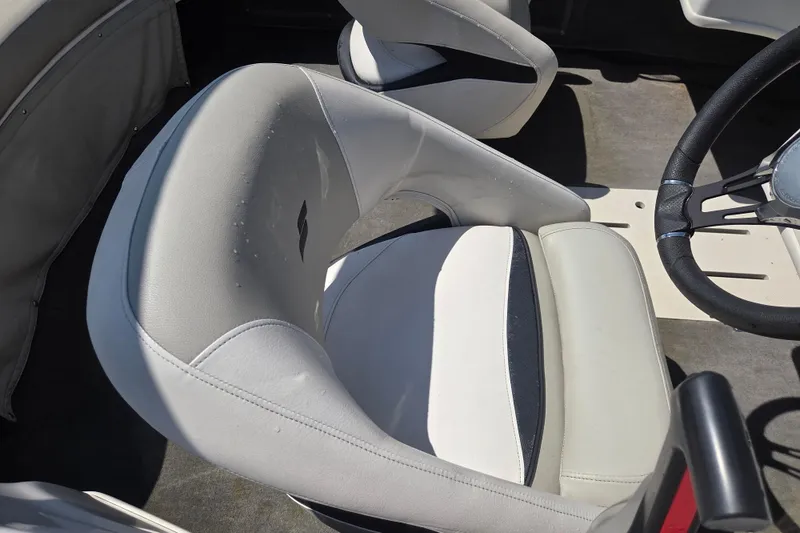 Slide: The Image of Interior of a 2020 Starcraft Limited Runabout 172 OB Sport boat, featuring a sleek seat and steering wheel. - 11