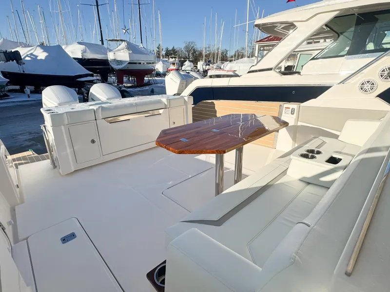 Slide: The Image of 2025 Tiara Yachts 43 LS luxury boat interior with seating and wooden table. - 9