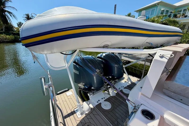 Slide: The Image of 2022 Cutwater C-32 CB boat with dual Yamaha engines and inflatable dinghy on deck. - 17