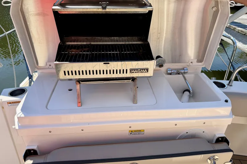 Slide: The Image of Outdoor grill and sink on a 2022 Cutwater C-32 CB boat. - 19