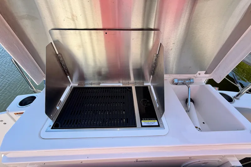 Slide: The Image of Outdoor grill and sink on 2022 Cutwater C-32 CB boat deck. - 21