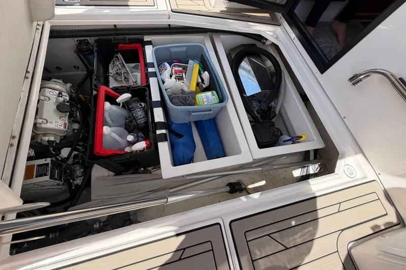 Slide: The Image of 2022 Cutwater C-32 CB boat storage compartment with organized supplies and equipment. - 22