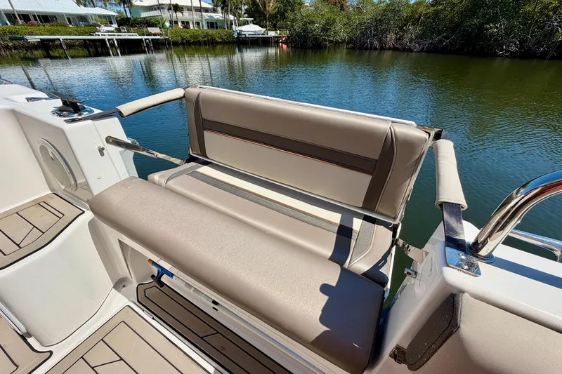 Slide: The Image of 2022 Cutwater C-32 CB boat with comfortable seating, docked by a serene waterfront. - 23
