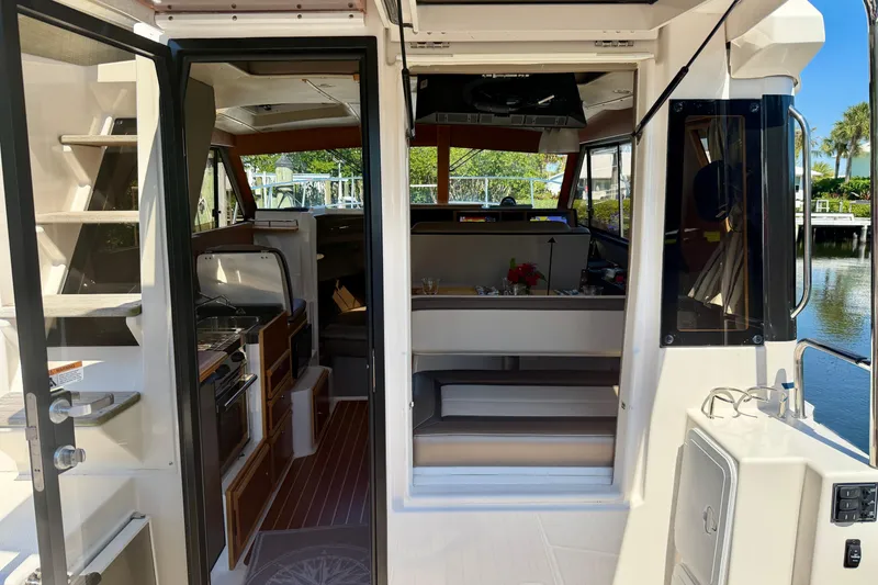 Slide: The Image of Interior view of 2022 Cutwater C-32 CB boat, featuring kitchen and seating area. - 29