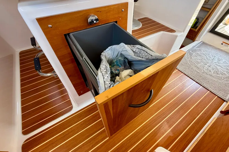 Slide: The Image of 2022 Cutwater C-32 CB boat interior with wooden flooring and open storage compartment. - 33