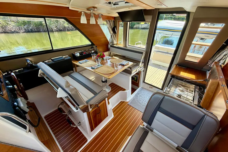 Slide: The Image of Interior of 2022 Cutwater C-32 CB boat with dining area and helm station. - 34