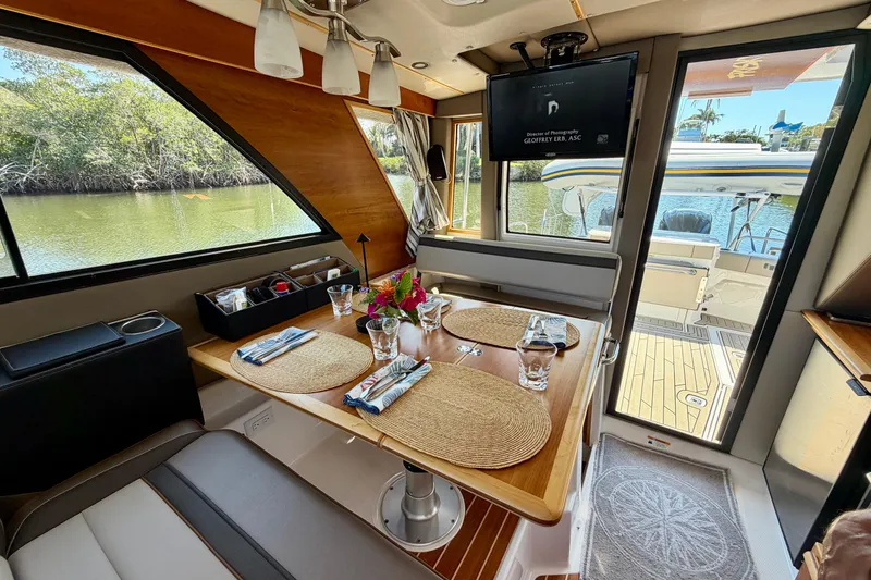 Slide: The Image of Interior of 2022 Cutwater C-32 CB yacht with elegant dining setup and scenic water view. - 35