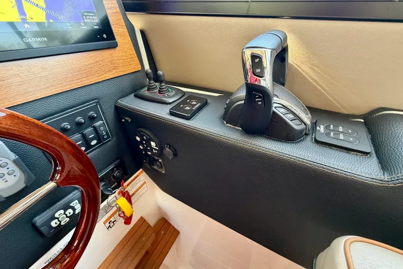 Slide: The Image of Control panel of 2022 Cutwater C-32 CB boat with steering wheel and navigation equipment. - 37