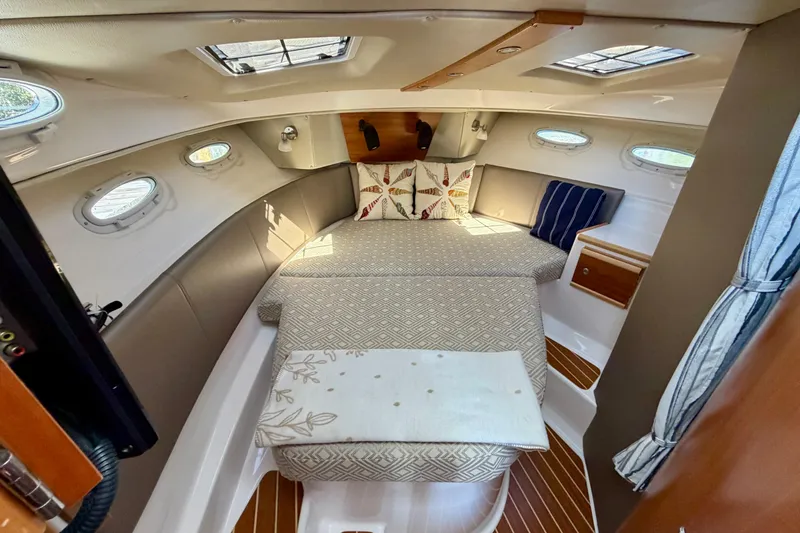 Slide: The Image of 2022 Cutwater C-32 CB cabin interior with cozy seating and decorative pillows. - 41