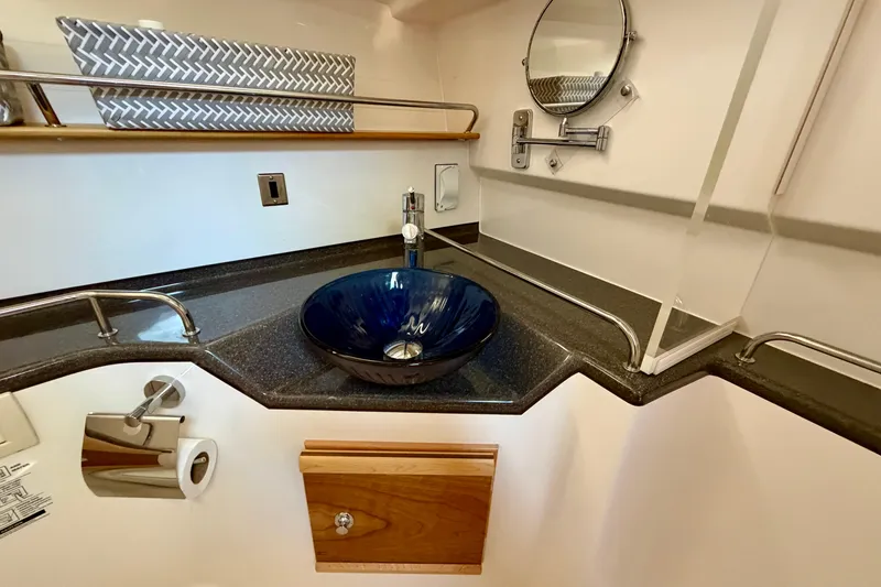 Slide: The Image of 2022 Cutwater C-32 CB bathroom with modern sink, mirror, and storage. - 44