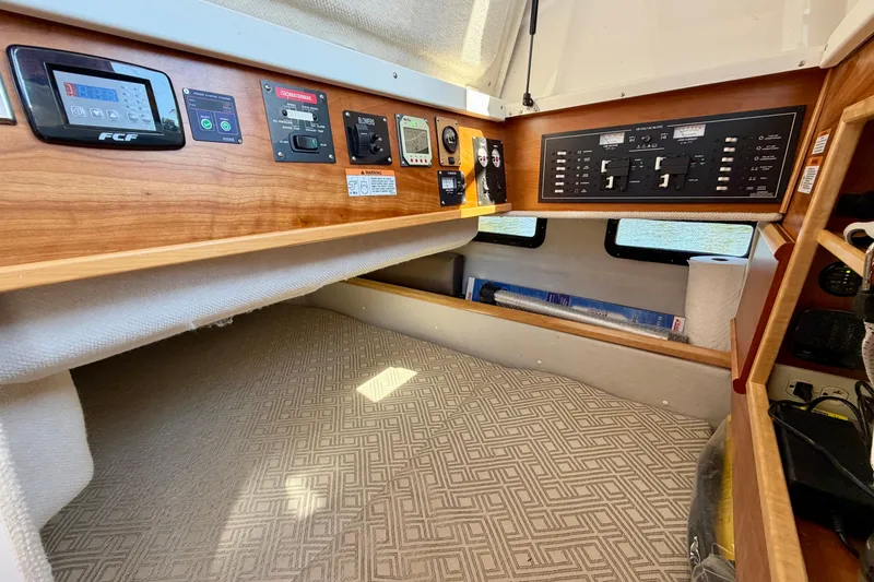 Slide: The Image of 2022 Cutwater C-32 CB cabin interior with control panels and cozy sleeping area. - 45