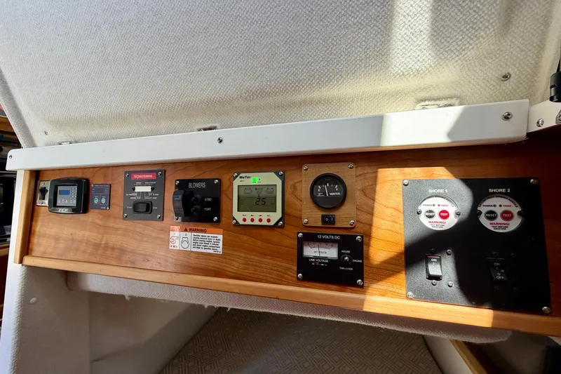 Slide: The Image of Control panel of 2022 Cutwater C-32 CB boat with various switches and gauges. - 47