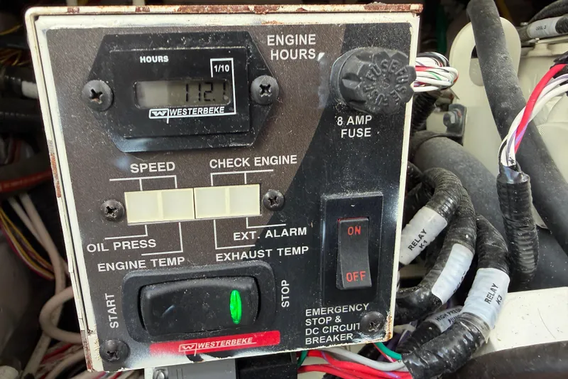 Slide: The Image of Control panel of a 2022 Cutwater C-32 CB boat, featuring engine hours and switches. - 49