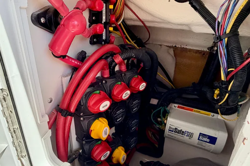 Slide: The Image of Electrical system of a 2022 Cutwater C-32 CB boat, featuring wiring and battery switches. - 51