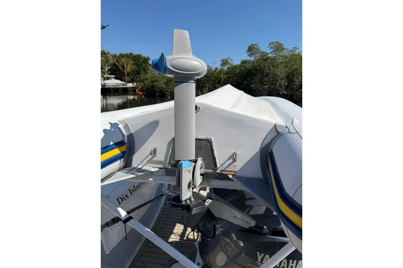 Slide: The Image of 2022 Cutwater C-32 CB boat with covered deck and Yamaha motor, docked near trees. - 55