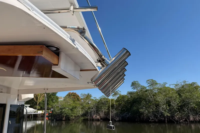 Slide: The Image of 2022 Cutwater C-32 CB boat detail with chrome exhaust pipes against a clear blue sky. - 57