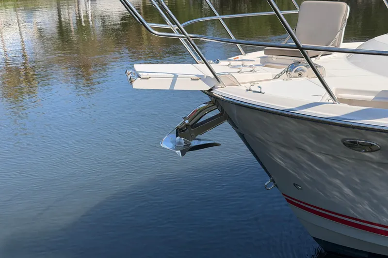 Slide: The Image of 2022 Cutwater C-32 CB boat anchored on calm water, showcasing sleek design and anchor detail. - 9