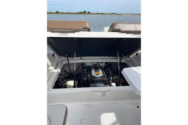 Slide: The Image of Open engine compartment of 2017 Chaparral 257 SSX boat on water. - 10