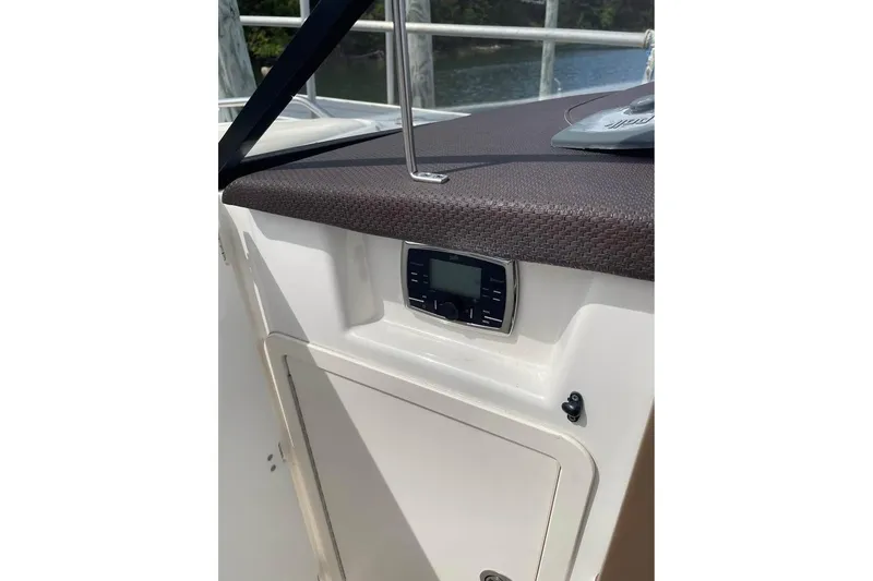 Slide: The Image of 2017 Chaparral 257 SSX boat dashboard with control panel and storage compartment. - 6