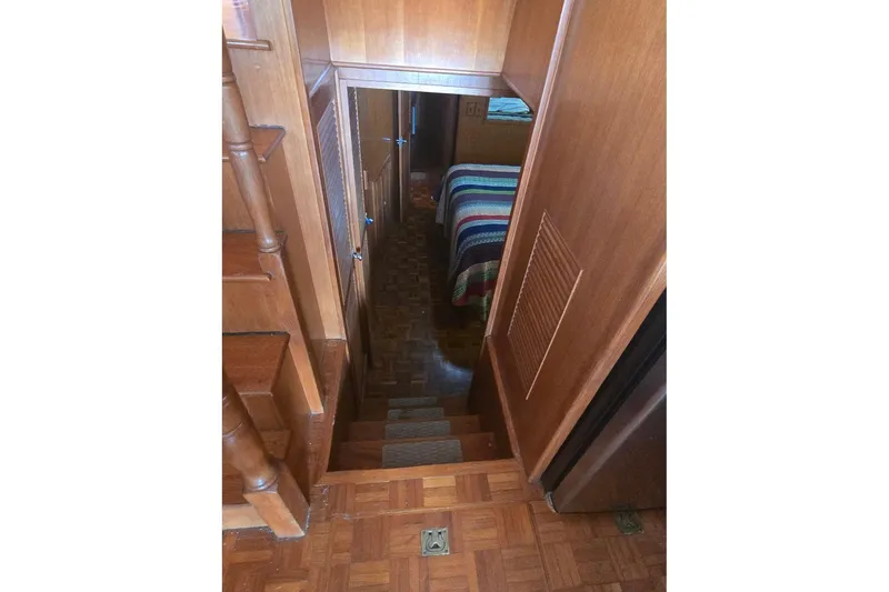 Slide: The Image of Interior view of 1982 Ocean Alexander 50 Mark I yacht, featuring wooden stairs and cozy cabin. - 10