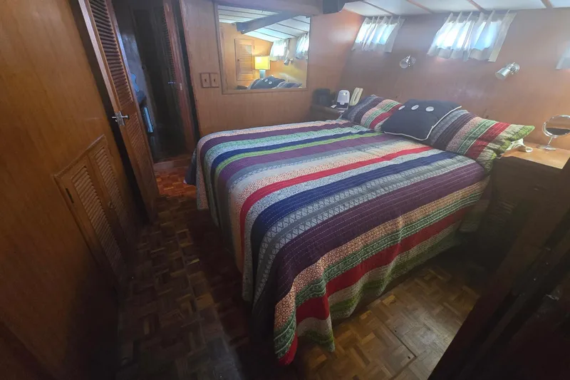 Slide: The Image of Cozy bedroom in 1982 Ocean Alexander 50 Mark I yacht with colorful striped bedding. - 11