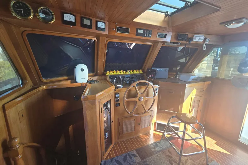 Slide: The Image of 1982 Ocean Alexander 50 Mark I yacht helm with wooden interior and navigation instruments. - 16