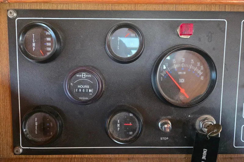 Slide: The Image of Instrument panel of a 1982 Ocean Alexander 50 Mark I yacht, showing gauges and ignition key. - 17