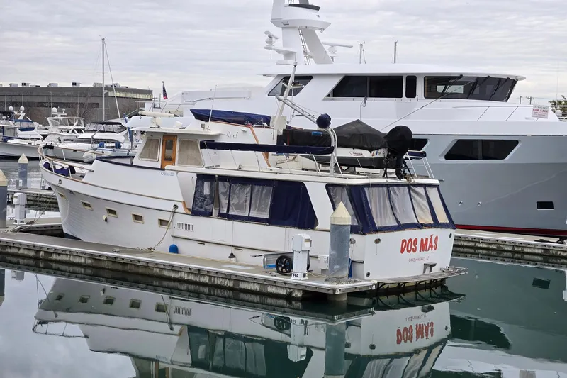 Slide: The Image of 1982 Ocean Alexander 50 Mark I yacht docked in marina, overcast sky. - 4
