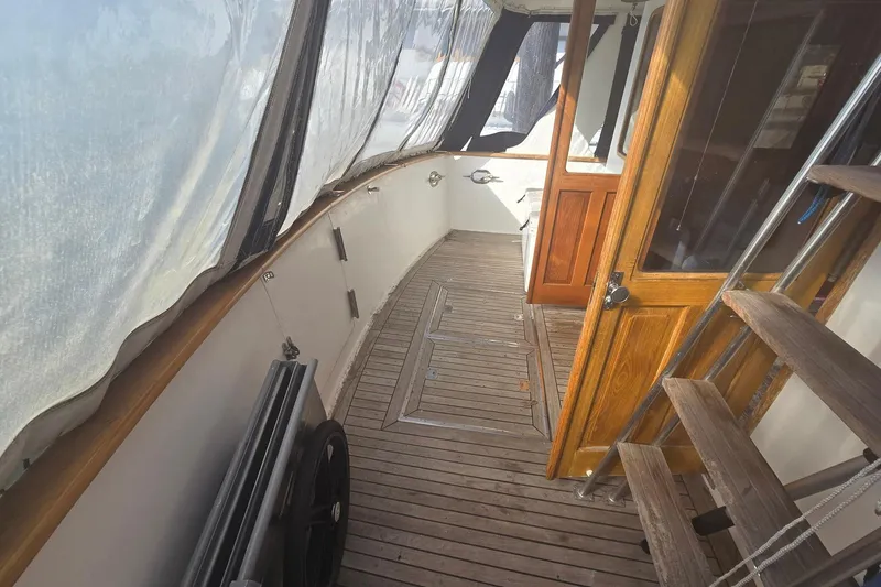 Slide: The Image of 1982 Ocean Alexander 50 Mark I yacht deck with wooden flooring and enclosed canopy. - 5