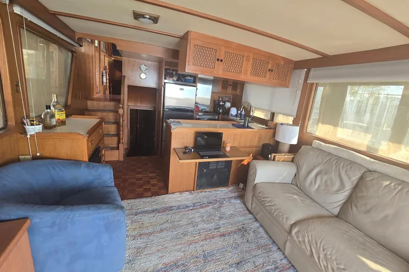Slide: The Image of Interior of 1982 Ocean Alexander 50 Mark I yacht with cozy seating and kitchen area. - 6