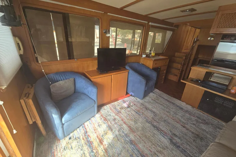 Slide: The Image of Interior of 1982 Ocean Alexander 50 Mark I yacht with cozy seating and TV. - 7