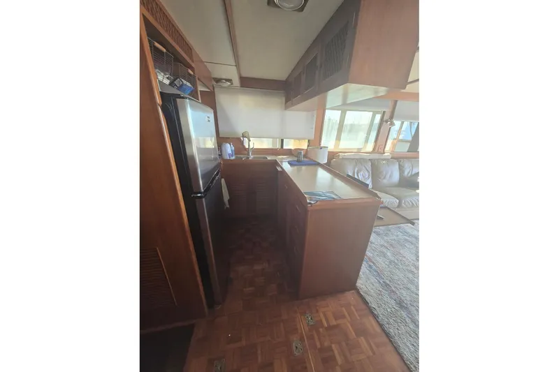 Slide: The Image of Interior of 1982 Ocean Alexander 50 Mark I yacht, featuring kitchen and living area. - 9
