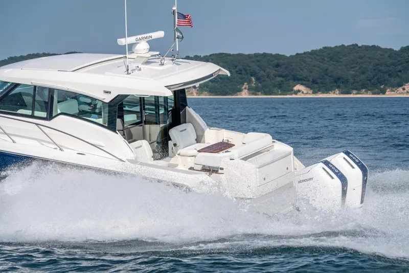 Slide: The Image of 2025 Tiara Yachts 43 LE cruising on water, showcasing sleek design and powerful engines. - 11