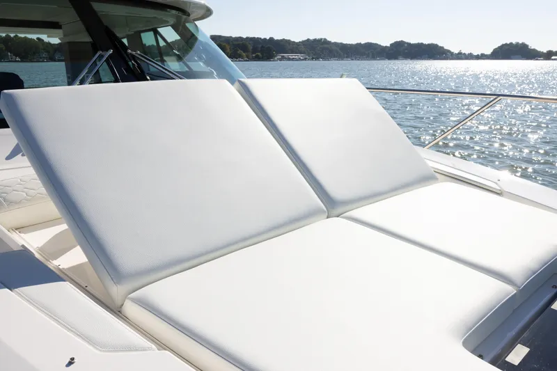 Slide: The Image of 2025 Tiara Yachts 43 LE sun deck with luxurious white cushions on a sunny day. - 28