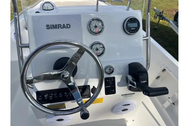 Slide: The Image of 2026 Key West 1720 Center Console boat dashboard with Simrad electronics and Yamaha controls. - 12