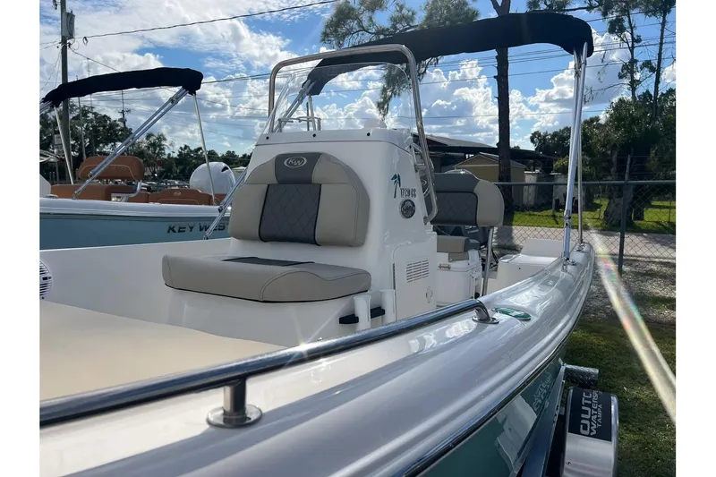 Slide: The Image of 2026 Key West 1720 Center Console boat with cushioned seating and canopy, parked outdoors. - 6