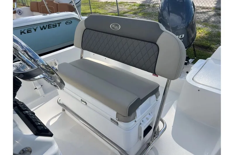 Slide: The Image of 2026 Key West 1720 Center Console boat interior with cushioned seating and steering wheel. - 9
