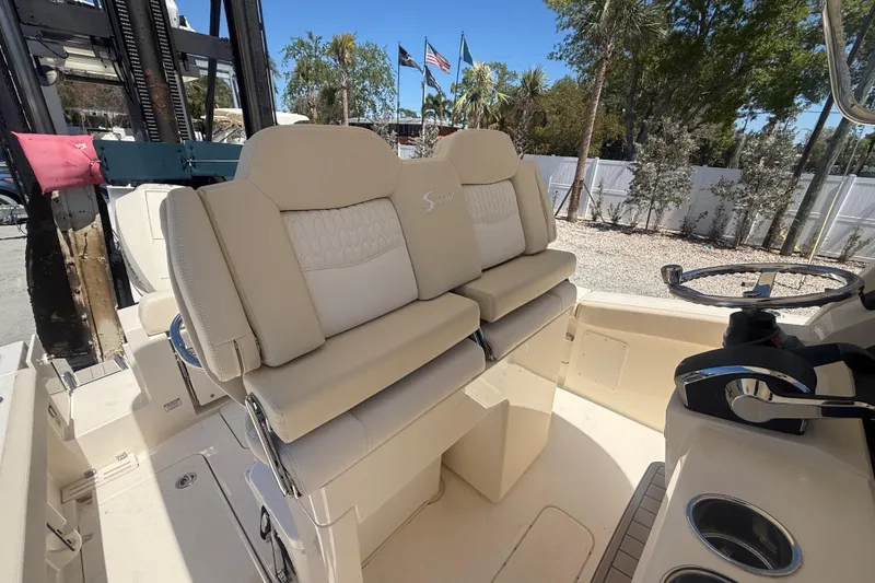 Slide: The Image of 2026 Scout 260 LXF boat interior with beige seating and steering wheel. - 10