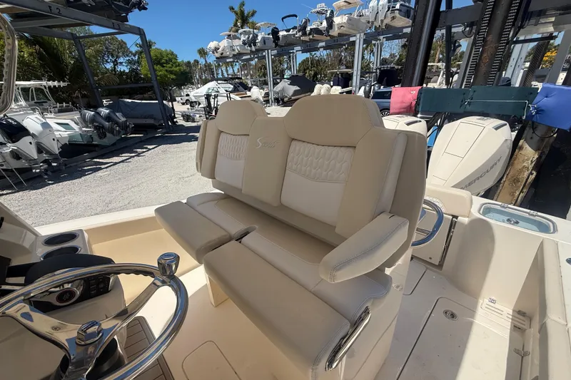 Slide: The Image of 2026 Scout 260 LXF boat interior with beige seating and steering wheel. - 11