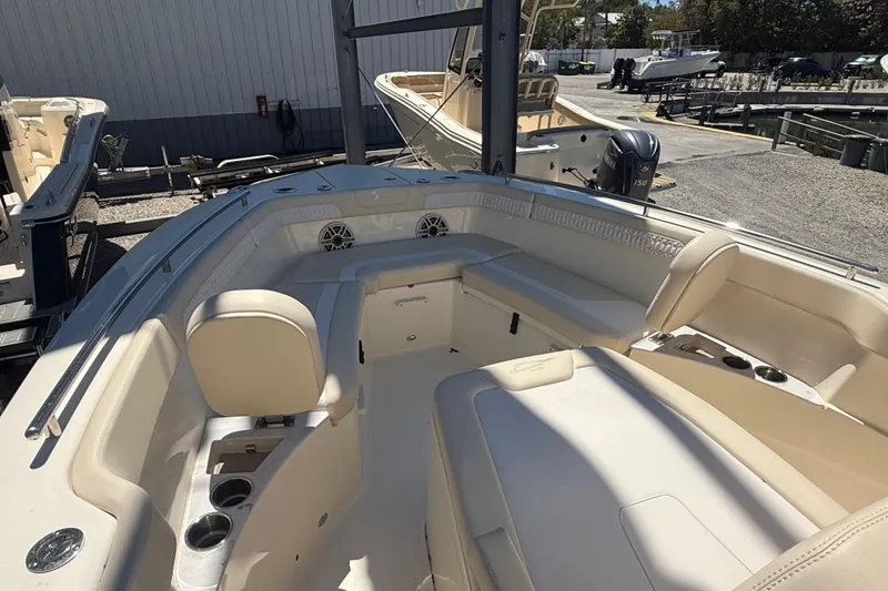 Slide: The Image of 2026 Scout 260 LXF boat interior with beige seating and cup holders. - 13