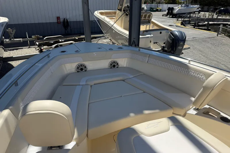 Slide: The Image of 2026 Scout 260 LXF boat interior with cushioned seating and speakers. - 17