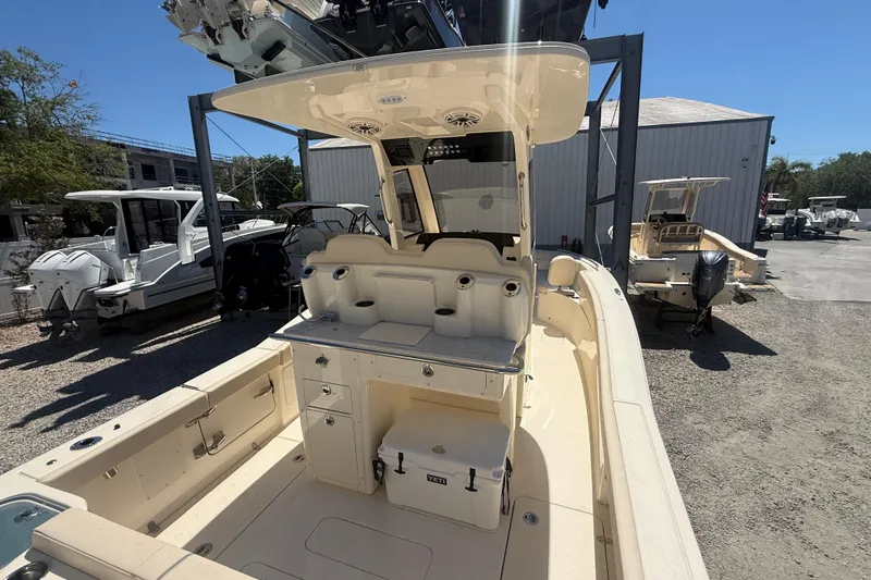 Slide: The Image of 2026 Scout 260 LXF boat interior with seating and storage, displayed outdoors. - 4