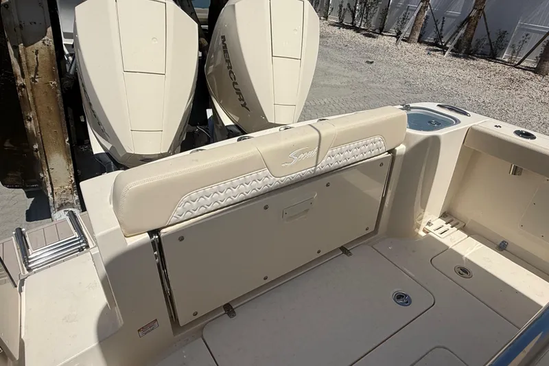 Slide: The Image of 2026 Scout 260 LXF boat with dual Mercury engines and beige seating. - 5