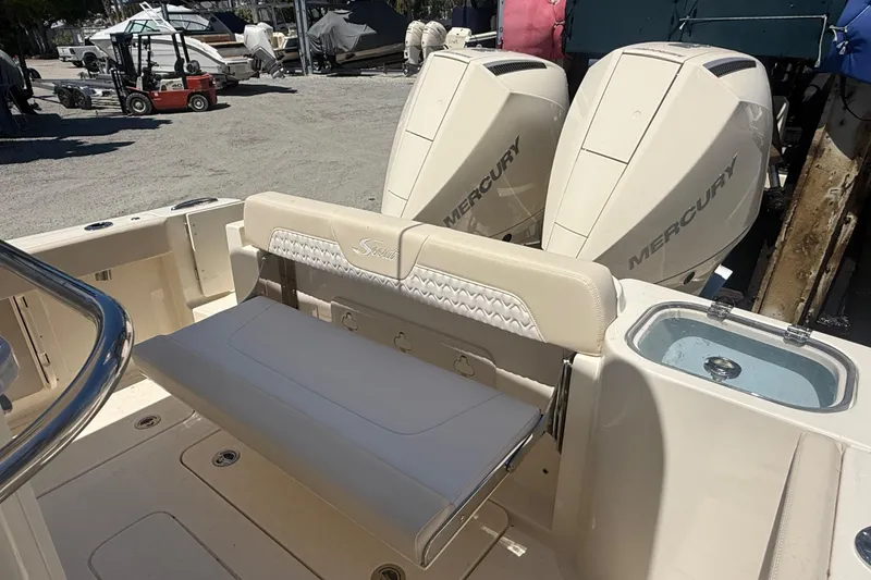 Slide: The Image of 2026 Scout 260 LXF boat with dual Mercury engines and seating area. - 6