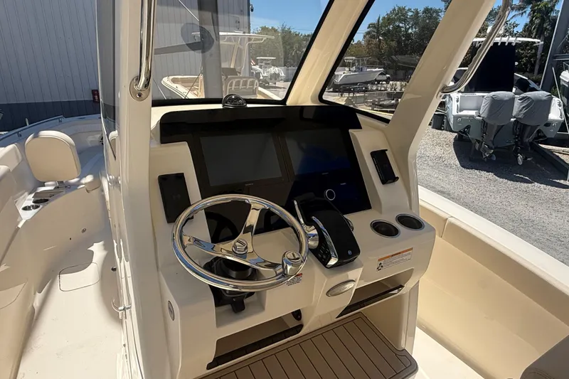 Slide: The Image of 2026 Scout 260 LXF boat cockpit with modern steering and controls. - 7