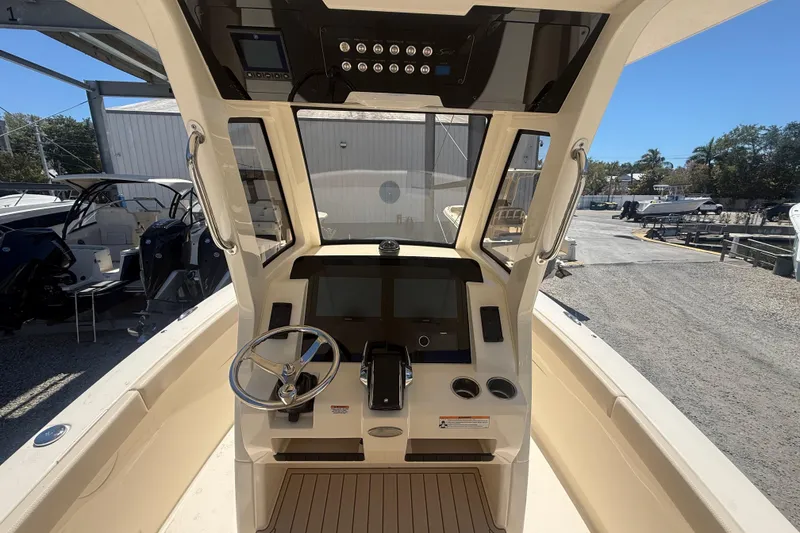Slide: The Image of 2026 Scout 260 LXF boat cockpit with steering wheel and control panel. - 8